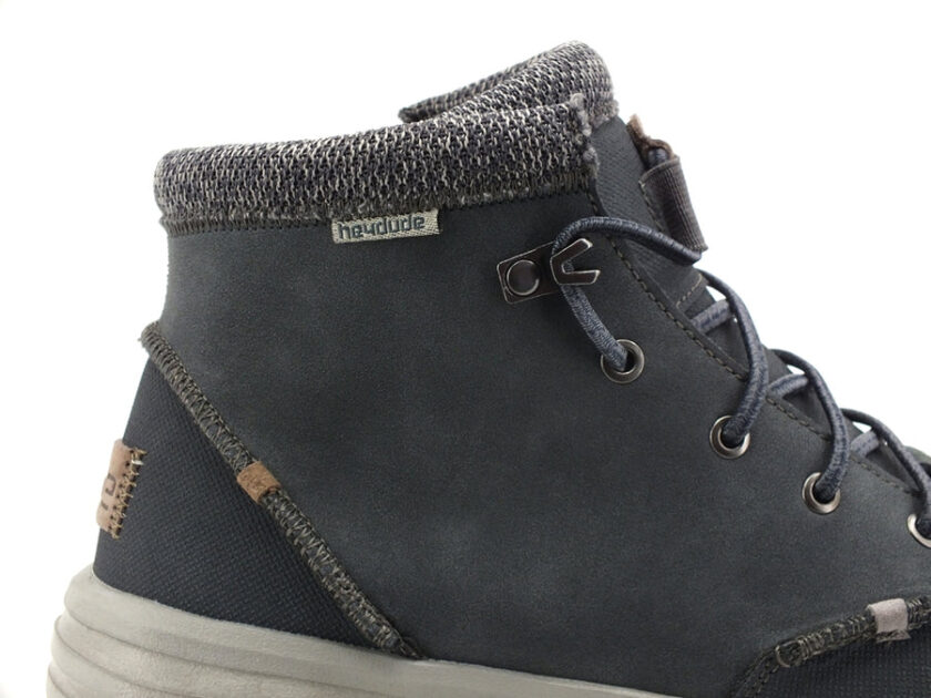 "Close-up side view of a Heydude 113302623 black ankle boot with gray knitted collar, black laces, and a light gray sole."