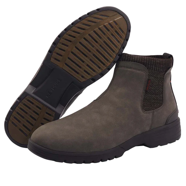 "Pair of Hey Dude men's boots, model 113311900, displayed with one boot upright and the other showing the outsole tread pattern; features an olive-brown suede upper, knit ankle collar, and durable rubber sole with traction grooves."