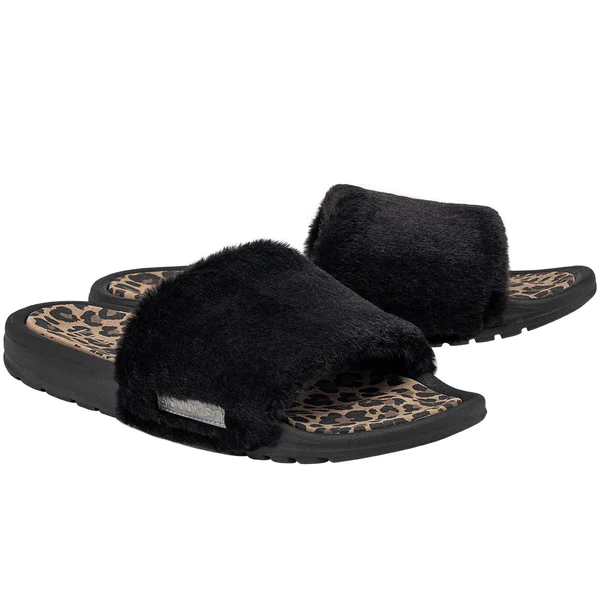 "Pair of black Heydude slide sandals with plush furry straps, leopard print footbeds, and black soles, angled view showing both sandals."