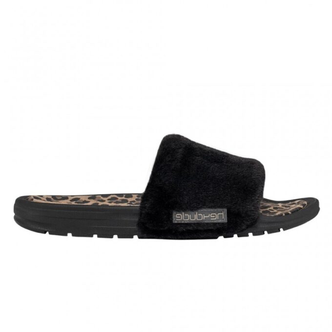 "Side view of a black Heydude slide sandal with a plush furry strap, leopard print footbed, and black sole with Heydude logo tag on the strap."