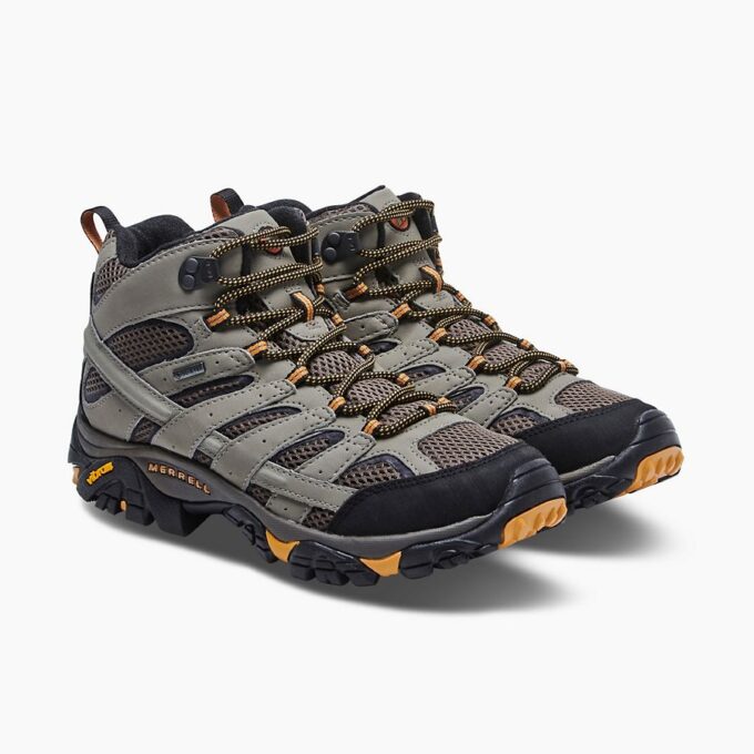 "Pair of Merrell J06057 hiking boots in gray and brown with black and orange accents, shown from a front three-quarter angle."