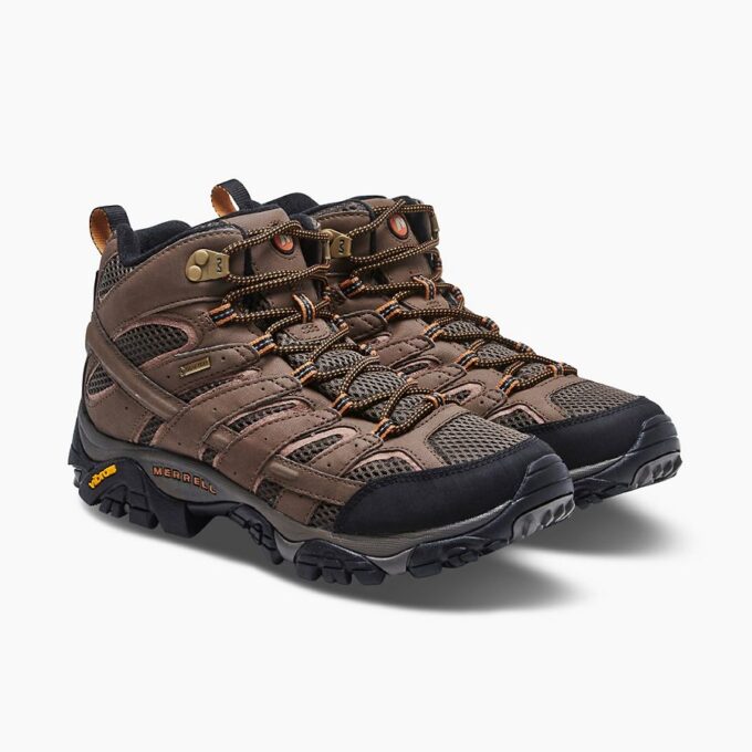 "Pair of brown Merrell J06063 hiking boots with black toe caps, black and orange laces, and rugged Vibram soles, angled to show the outer sides and front."