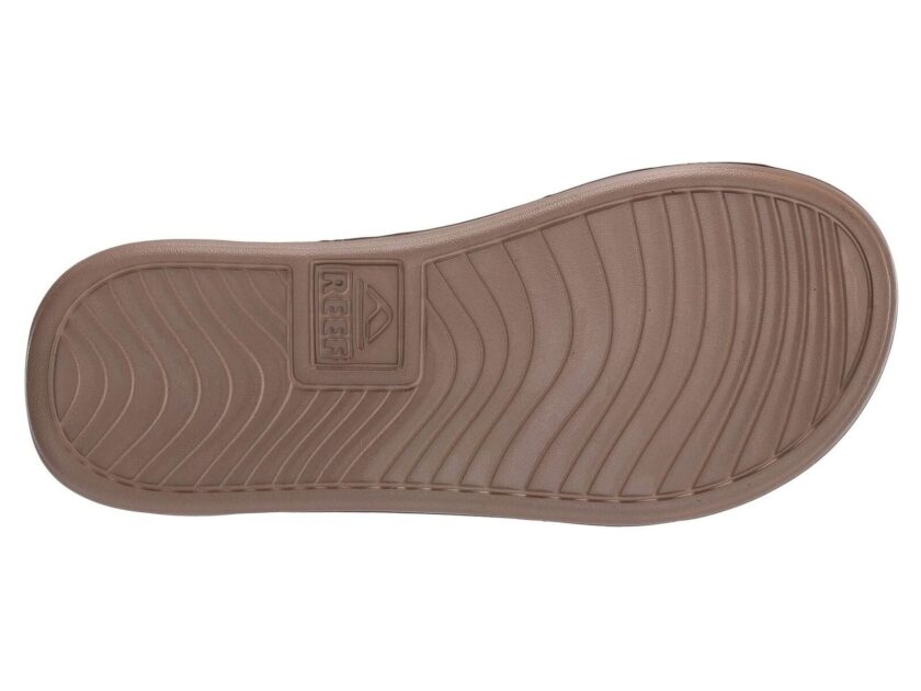 "Bottom view of a single brown Reef RF0A3ONCBRO sandal showing the textured rubber sole with the Reef logo embossed near the heel."