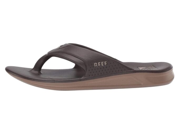 "Side profile of a brown Reef RF0A3ONCBRO sandal featuring a contoured footbed, perforated upper strap with the Reef logo, and a two-tone sole."