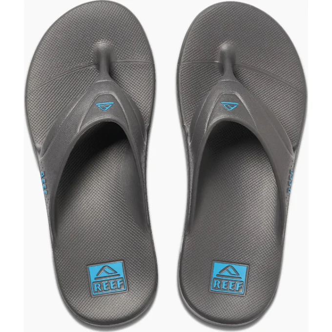 "Top view of a pair of gray Reef flip-flop sandals featuring blue Reef logos on the footbeds and straps."