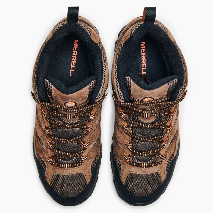 "Top-down view of a pair of brown Merrell J06051 hiking boots with black and orange accents, orange and black laces, and "MERRELL" branding visible on the insoles and tongue."