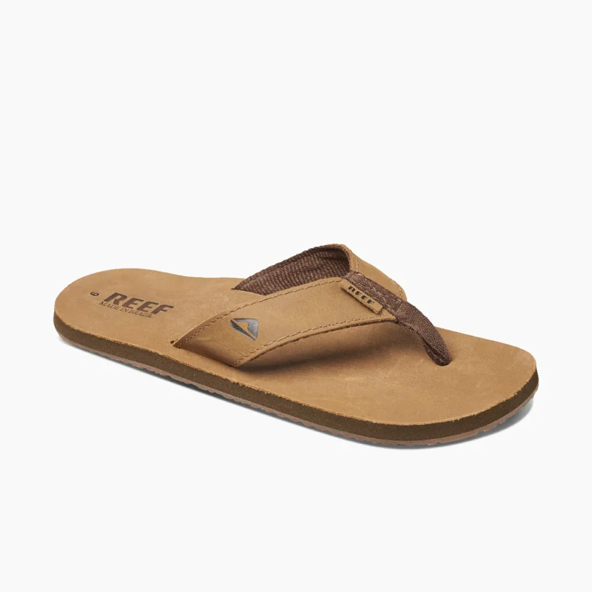"Angled side view of a brown Reef RF000232BZB flip-flop sandal with dark brown fabric thong strap."