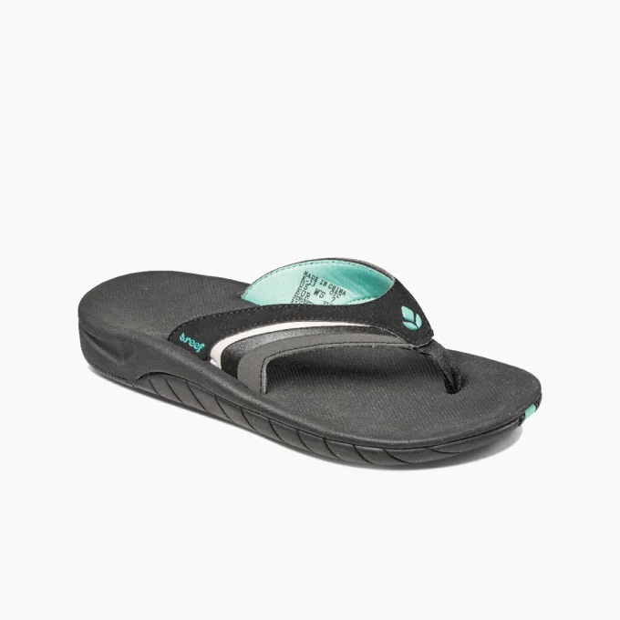 “Angled front view of a Reef RF001084BKQ flip-flop sandal in black with teal and gray accents, showing the contoured footbed, toe post, and textured sole.”