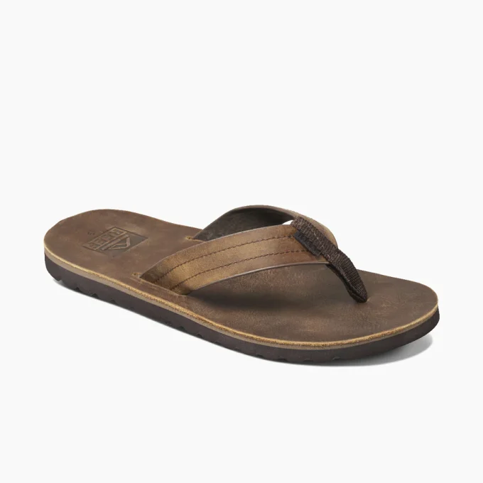 "Angled view of brown Reef RF0A2YFRDAB flip-flop with stitched thick strap and dark textured sole."