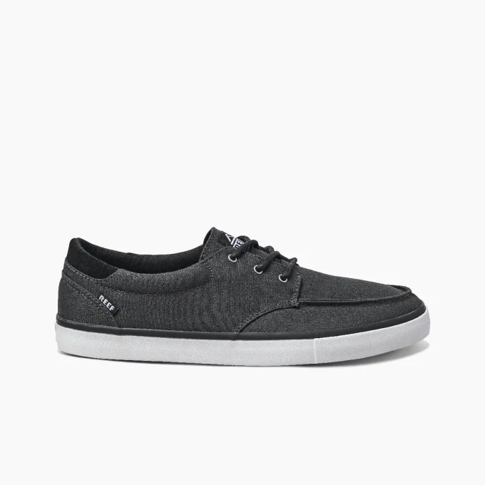"Side view of Reef RF0A3FE4BLW men's casual shoe in black with white outsole, black laces, and subtle Reef branding near the heel."