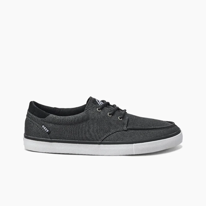 "Side view of Reef RF0A3FE4BLW men's casual shoe in black with white outsole, black laces, and subtle Reef branding near the heel."