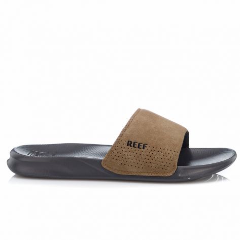 "Side view of Reef RF0A3ONDGTA slide sandal featuring a black sole and a brown perforated suede strap with the Reef logo."