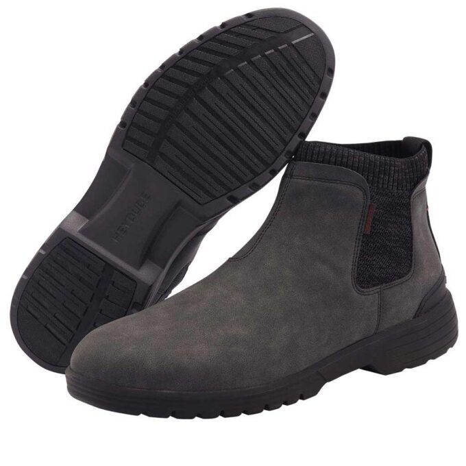 "Hey Dude men’s dark gray slip-on ankle boots featuring a flexible rubber outsole, rounded toe, and stretch-knit side panels for easy wear." "Side and bottom view of Hey Dude men's casual slip-on boots in charcoal gray with treaded outsole for grip and ribbed ankle collar for comfort." "Men’s Hey Dude ankle-high slip-on boot in dark gray with lightweight outsole, slip-resistant tread, and textured stretch panels on the sides."
