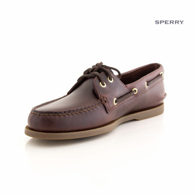 "Front-side view of a Sperry A/O Amaretto boat shoe in smooth dark brown leather with moc-toe stitching, gold eyelets, brown leather laces, and a light brown rubber sole."