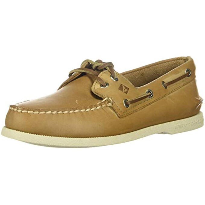 "Angled view of a tan Sperry A/O Oatmeal boat shoe featuring moc-toe stitching, brown rawhide laces threaded through metal eyelets, and a white non-marking rubber outsole."