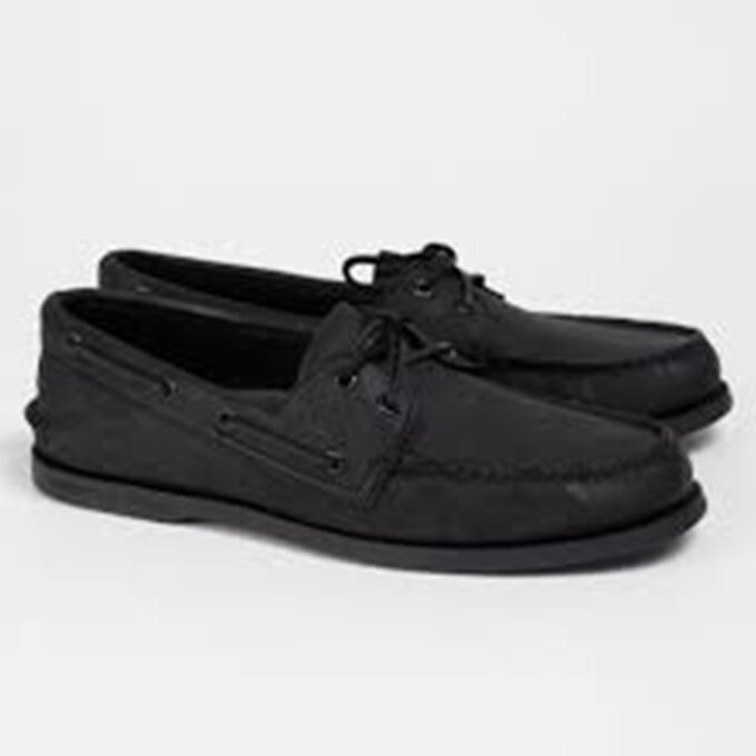 "Side profile view of black leather Sperry A/O 2 Eye boat shoe pair with moc toe and leather laces threaded through metal eyelets."