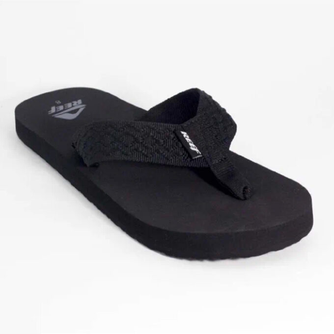 “Black Reef Smoothy flip-flop sandal with a textured fabric thong strap and cushioned sole, showing the Reef logo on the footbed and strap.”