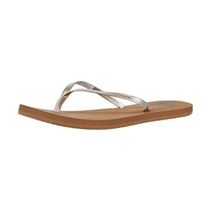 "Side view of Reef Bliss Nights sandal (RF0A2U1JTAH) in tan with metallic vegan leather crisscross straps and rubber sponge outsole, shown on a white background."