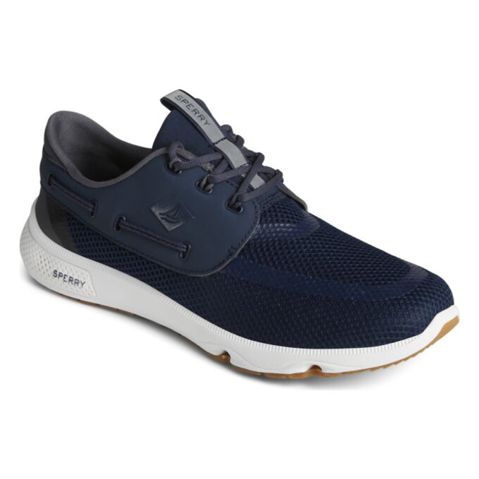 "Angled view of Sperry 7 SEAS 3-Eye - STS24363 shoe in navy blue, featuring a mesh upper for breathability, a durable lace-up design with a side panel sailboat logo, and a white and gum rubber sole designed for traction and comfort."