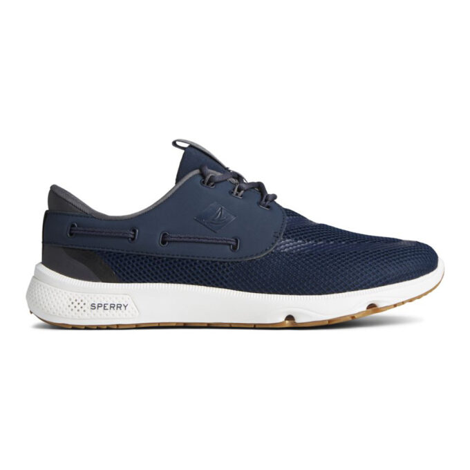 "Side profile view of the Sperry 7 SEAS 3-Eye - STS24363 shoe in navy blue, showcasing its breathable mesh upper, synthetic overlay with integrated lacing system, embossed sailboat logo, and a cushioned white midsole with gum rubber outsole designed for superior grip on wet surfaces."